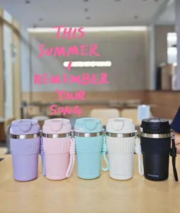 Detailed view of portable stainless steel coffee cups with silicone sleeves and lanyards in multi-color options.