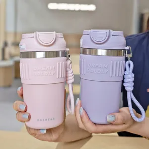 Insulated stainless steel coffee cup with silicone sleeve and portable strap for daily use.