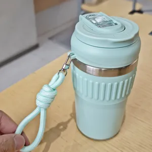 Mint green stainless steel coffee cup with silicone sleeve, portable straw and dual-drink lid.