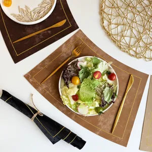Modern waterproof leather placemat set with gold trim, stylish table mat for dining room decor.