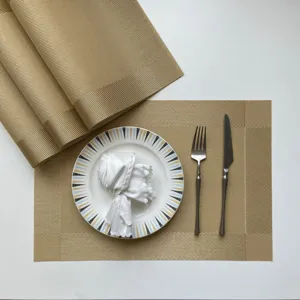 Gold woven PVC placemat set, non-slip heat insulation table mat for modern dining decor.