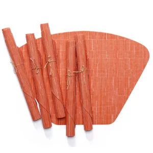 Set of orange fan-shaped Teslin PVC placemats for dining table heat insulation and decor.