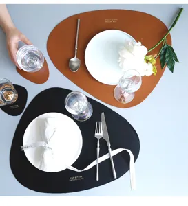 Detailed closeup of irregular triangular PU leather placemat with waterproof and heat insulation.