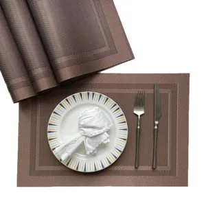 Brown PVC woven placemat set, elegant thermal insulated table mat with plate and cutlery for hotel.