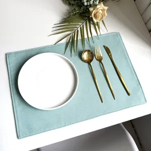 Light blue imitation linen placemat detail, showing texture, tableware styling, and table setup.