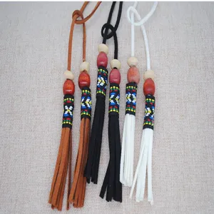 Detail shot of bohemian ethnic leather tassel necklace and dress waist rope with beads.
