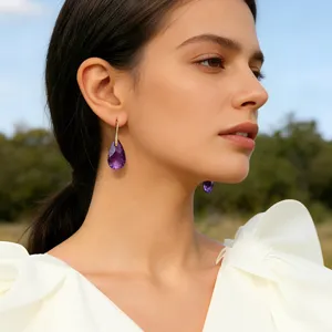 Elegant teardrop purple crystal earrings with gold hook, perfect for luxury resort fashion wear.