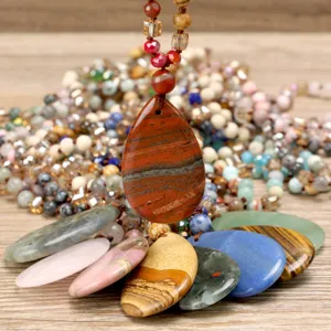 Handmade natural stone teardrop pendant necklace detail showing exquisite gemstone texture and knot.