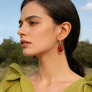 Faceted teardrop gemstone earrings with gold-tone hook, perfect for elegant resort style.