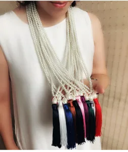 Elegante lange Perlenkette mit mehreren Strängen und bunten Stoffquasten für Damen.