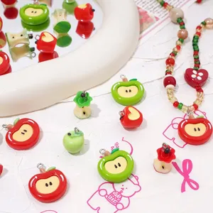 Close-up of colorful resin apple charms and beads, perfect for handmade DIY jewelry making.