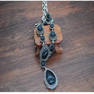 Vintage silver tone black stone long sweater necklace detail shot, elegant vintage jewelry piece.