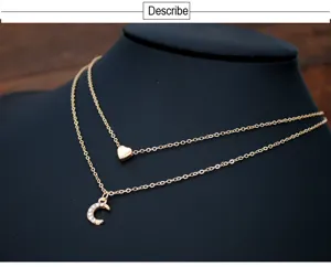 Gold multi-layer necklace with heart and rhinestone moon pendant for women fashion jewelry.