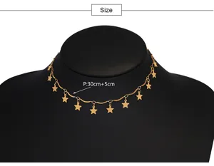Close-up detail of a gold star choker necklace showing delicate metal chain and star charms.