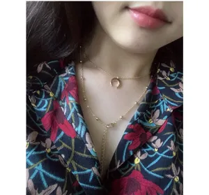 Gold multi-layer necklace for women with moon pendant and dainty clavicle chain jewelry.
