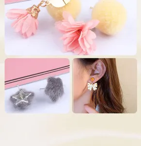 Detailopname van handgemaakte stoffen bloemen en pluche bal oorbellen accessoires voor DIY.