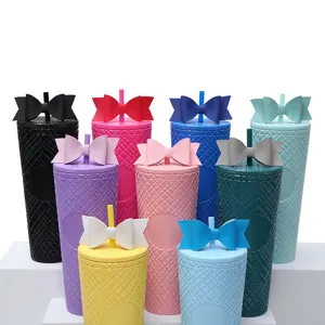 Detailed view of colorful studded tumblers with large bow decor and straws, cute design.