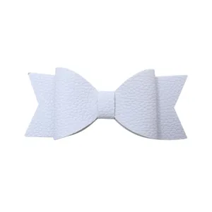 White faux leather bow hair accessory close-up detail showcasing fine texture and design.