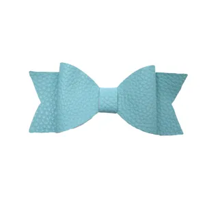 Close-up view of the light blue textured leather bow hair clip detail and fine craftsmanship.