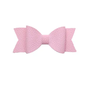 Pink faux leather bow accessory, detailed close-up shot of cute decorative hair or cup charm.