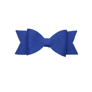 Close-up detail of a vibrant blue faux leather decorative bow accessory with textured design.