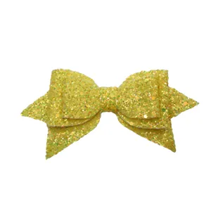 Yellow glitter bow accessory detail shot, beautiful sparkling decorative piece for creative cups.