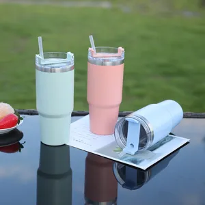 Large capacity stainless steel thermal tumbler cup with straw and handle for outdoor travel use.