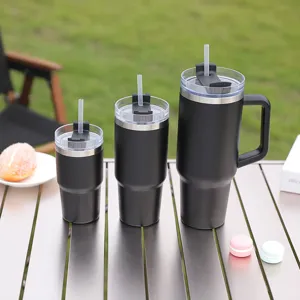 Stainless steel thermal tumbler set with handle and straw lid for outdoor camping and travel use.
