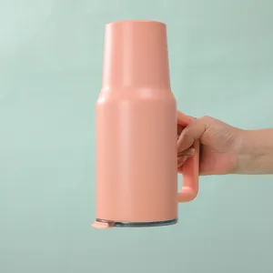 Pink 40oz stainless steel insulated tumbler with handle and leak-proof lid for travel.