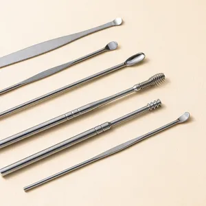 Close-up detail of stainless steel ear pick tool set showing precise metal craftsmanship.