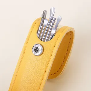 Stainless steel ear pick detail shot showing smooth tools and yellow leather case design.