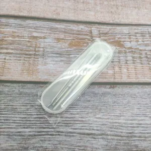 Stainless steel ear pick set detail showing metal tools inside a clear plastic case and wrap.