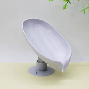 Leaf shaped soap dish holder with suction cup drainage design for bathroom kitchen use.