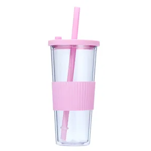Double wall plastic tumbler with straw and pink silicone sleeve for boba tea, large capacity.