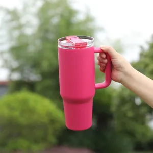 Stainless steel insulated tumbler with handle and straw lid, pink car cup for outdoor use.