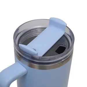 Detail shot of the insulated tumbler lid and handle in light blue, showing clear seal and slider.
