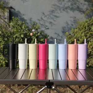 Stainless steel insulated tumbler with handle and straw, colorful car cup for cold drinks.