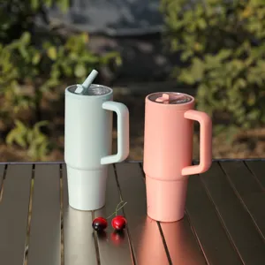 Large capacity stainless steel insulated tumbler with handle and foldable straw lid for travel.