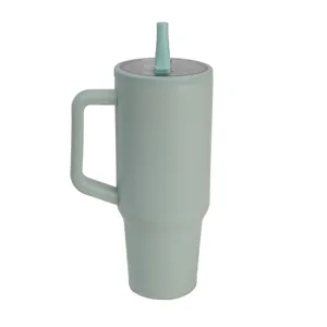 Close-up view of light green 40oz stainless steel travel tumbler with handle and straw lid.