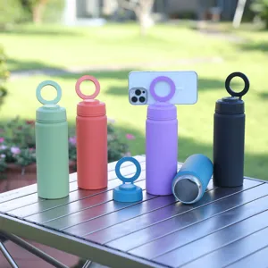 Stainless steel vacuum insulated water bottle with magnetic phone holder ring for outdoor sports.