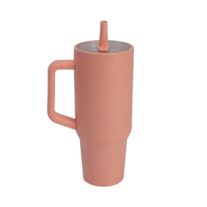 Stainless steel tumbler detail showing ergonomic handle and convenient straw lid design.