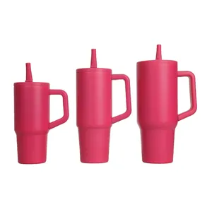 Pink stainless steel tumbler with handle and straw lid, ideal for car and travel use.