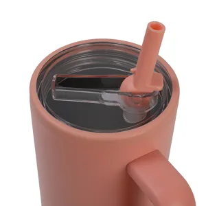 Detailed view of the pink stainless steel insulated tumbler lid and straw mechanism.