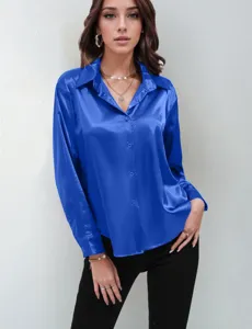 Royal blue satin blouse detail, long sleeves with button cuffs, elegant lapel collar design.
