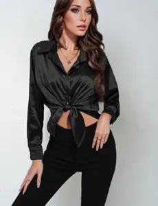 Women black satin long sleeve tied blouse detail shot, elegant silk-like lapel shirt top.