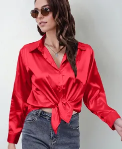 Detailed view of the elegant red satin long-sleeve blouse with front tie knot and collar.