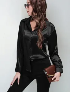 Close-up view of a black satin button-down blouse with long sleeves and elegant lapel.