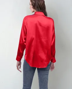 Back detail view of a vibrant red satin long sleeve blouse showing texture and elegant fit.