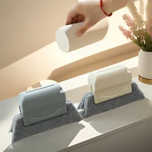 Detail view of window gap cleaning brush with grey scouring pad and plastic handle for sills.