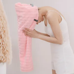Vue détaillée d'un bonnet de bain rose doux et absorbant porté par un mannequin féminin.